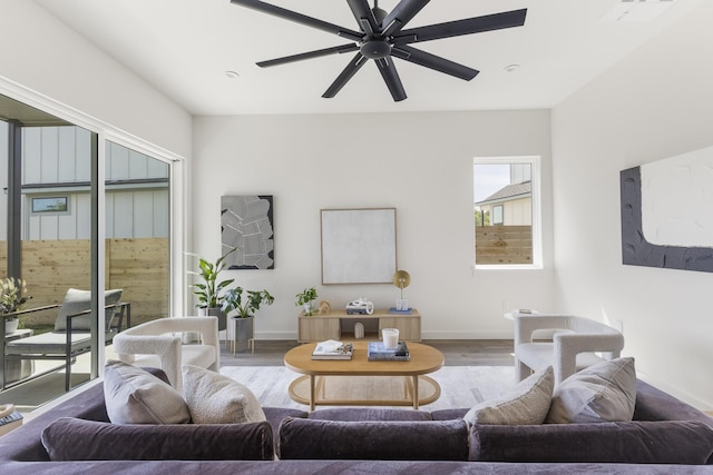 living room featuring ceiling fan and hardwood / wood-style floors