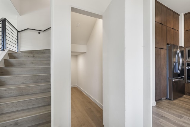 stairs with hardwood / wood-style flooring