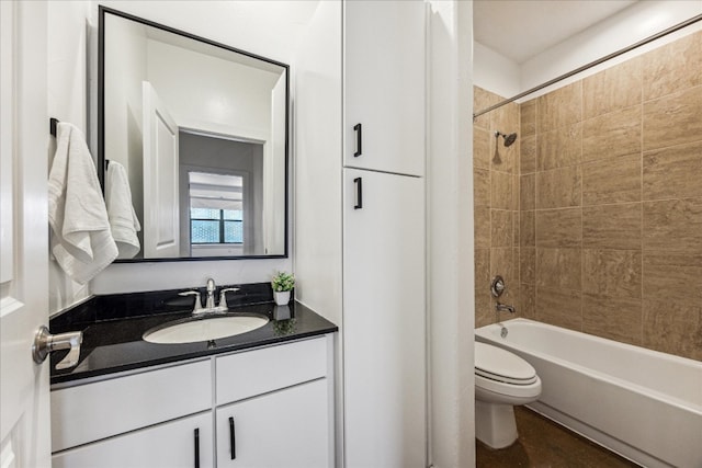 full bathroom with vanity, toilet, and tiled shower / bath combo