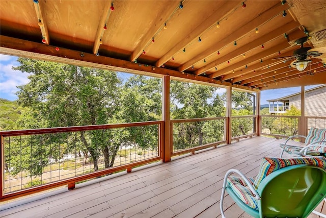 wooden terrace featuring a ceiling fan