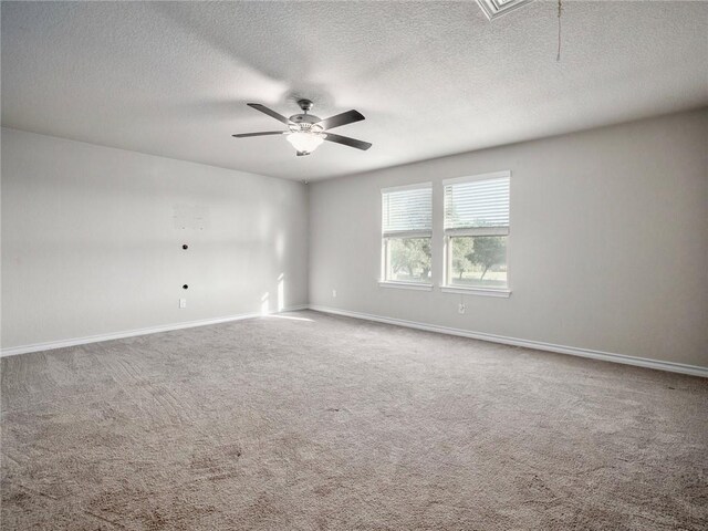 245 Tulum Ter, Leander, TX 78641 - spare room with a textured ceiling, a ceiling fan, carpet flooring, and attic access