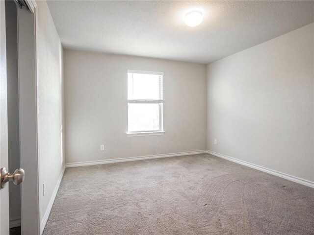 245 Tulum Ter, Leander, TX 78641 - spare room with carpet flooring and a textured ceiling