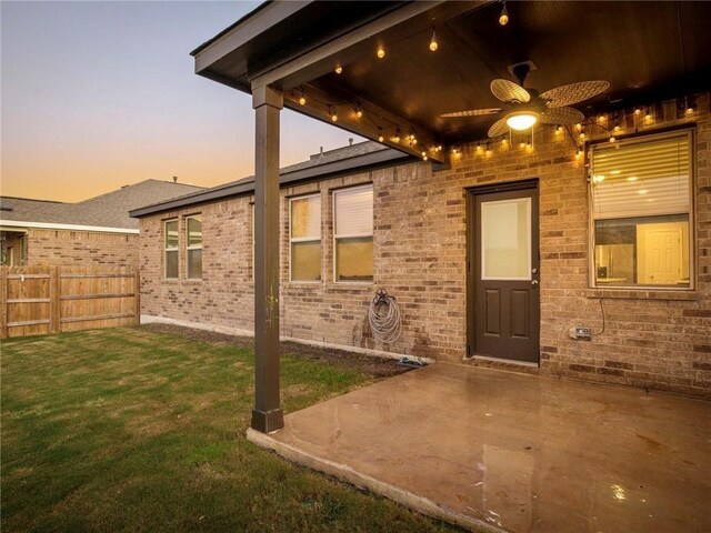 245 Tulum Ter, Leander, TX 78641 - property entrance featuring a ceiling fan, brick siding, and a patio area