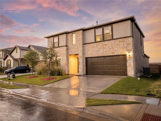 245 Tulum Ter, Leander, TX 78641 - view of front of property with stone siding, concrete driveway, an attached garage, and stucco siding