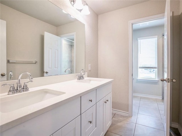 245 Tulum Ter, Leander, TX 78641 - bathroom featuring double vanity and tile patterned floors