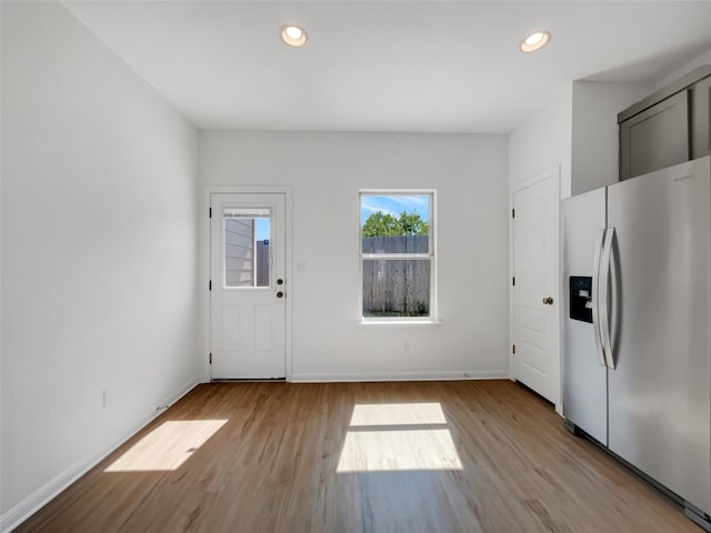 kitchen featuring light hardwood / wood-style floors and stainless steel fridge with ice dispenser