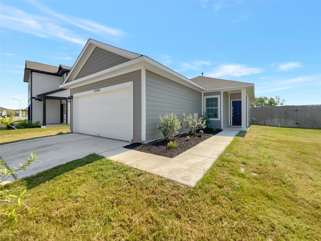 ranch-style house featuring a front lawn and a garage