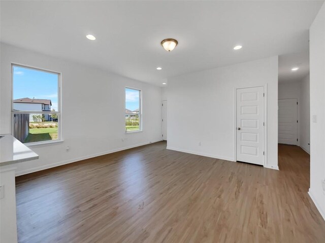 unfurnished living room featuring hardwood / wood-style flooring