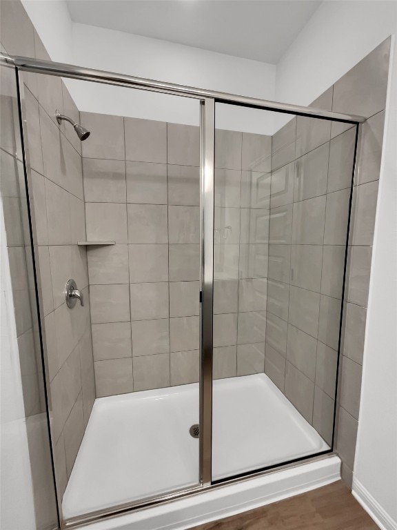 bathroom featuring wood-type flooring and walk in shower