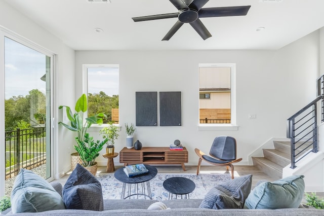 living room featuring ceiling fan and hardwood / wood-style floors