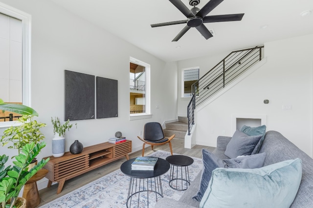 living room with wood-type flooring and ceiling fan