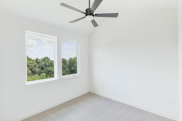 carpeted spare room with vaulted ceiling and ceiling fan