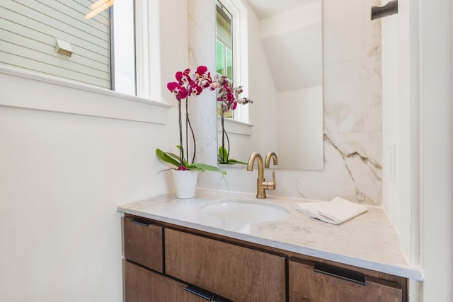 bathroom featuring vanity and vaulted ceiling