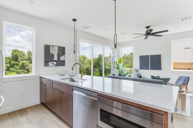 kitchen featuring plenty of natural light, stainless steel appliances, sink, and ceiling fan