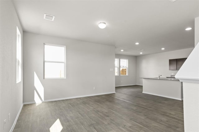 unfurnished living room with dark hardwood / wood-style flooring