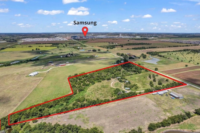 birds eye view of property with a rural view