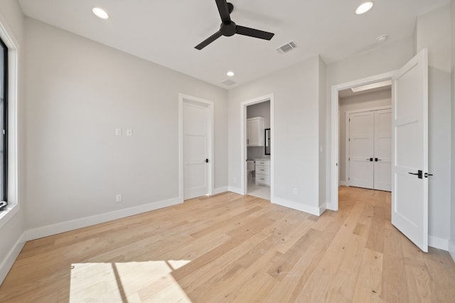 unfurnished bedroom with ceiling fan, connected bathroom, and light hardwood / wood-style floors