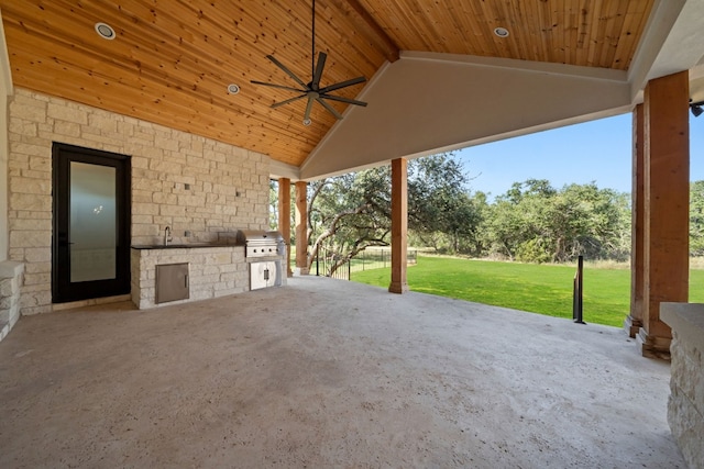 view of patio / terrace with a grill, ceiling fan, and an outdoor kitchen