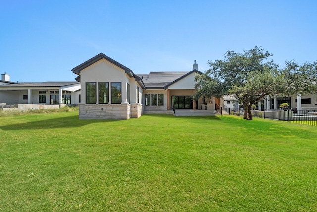 back of house with a lawn