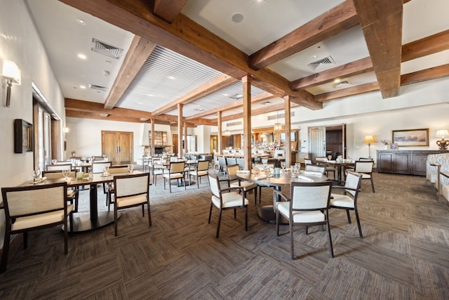 dining space featuring dark carpet and beam ceiling