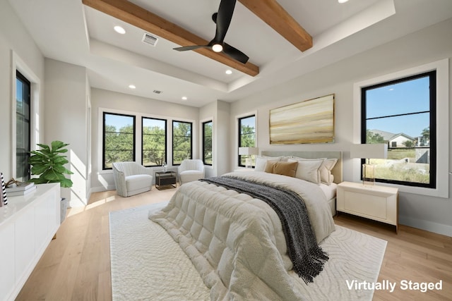 bedroom with ceiling fan, beam ceiling, and light hardwood / wood-style flooring