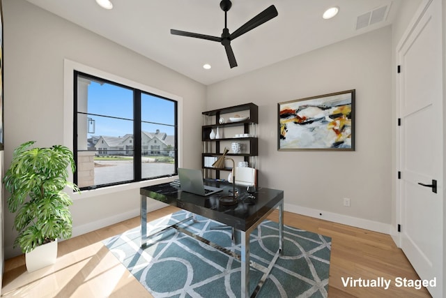 home office featuring ceiling fan and light hardwood / wood-style flooring