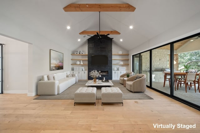 living room with beamed ceiling, a tile fireplace, high vaulted ceiling, and light hardwood / wood-style floors