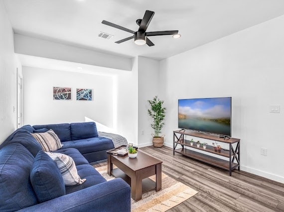 living room with hardwood / wood-style floors and ceiling fan