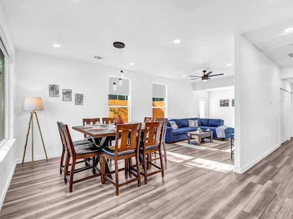 dining room featuring wood-type flooring and ceiling fan