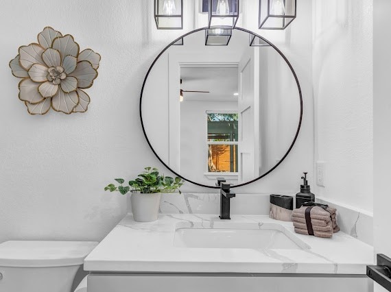 bathroom featuring toilet and vanity