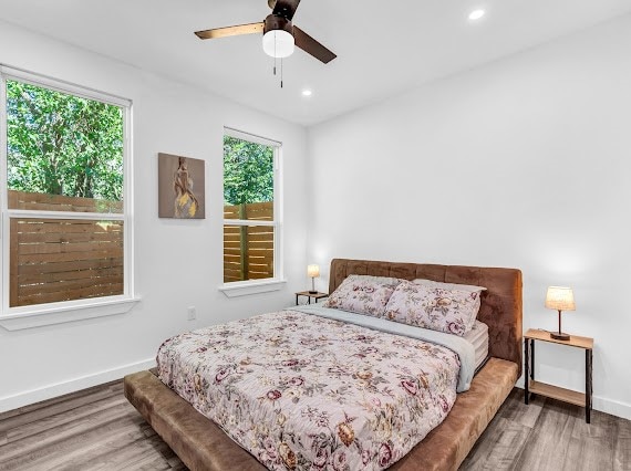 bedroom with wood-type flooring and ceiling fan