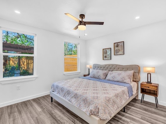 bedroom with ceiling fan and hardwood / wood-style flooring