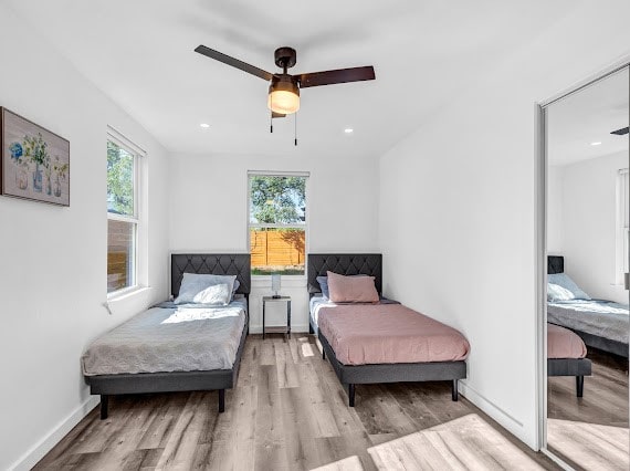 bedroom with light wood-type flooring and ceiling fan