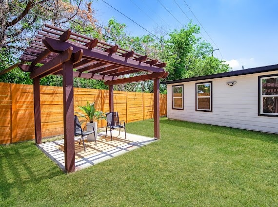 view of yard with a pergola and a patio area