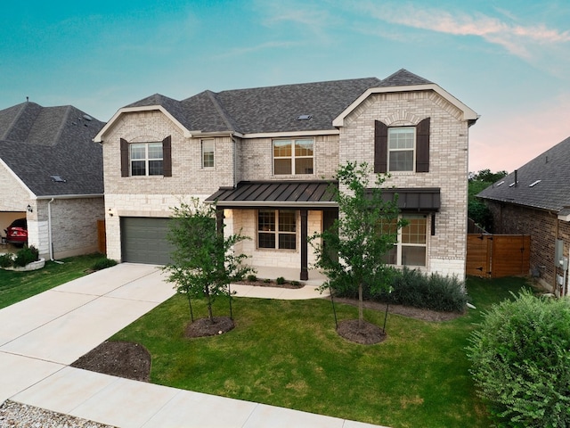 view of front of home featuring a lawn and a garage