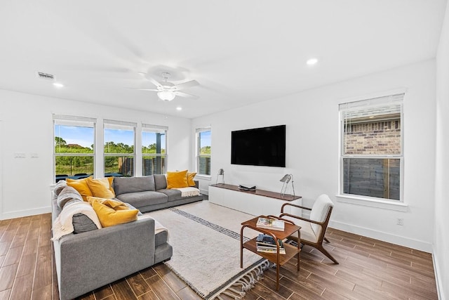 living room featuring wood-type flooring and ceiling fan