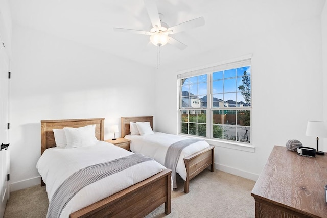 bedroom with light colored carpet and ceiling fan