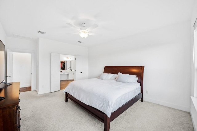 carpeted bedroom with ceiling fan and connected bathroom