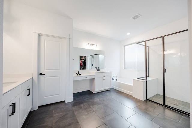 bathroom featuring vanity, independent shower and bath, and tile patterned floors