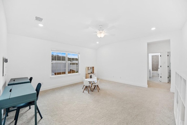 carpeted home office featuring ceiling fan