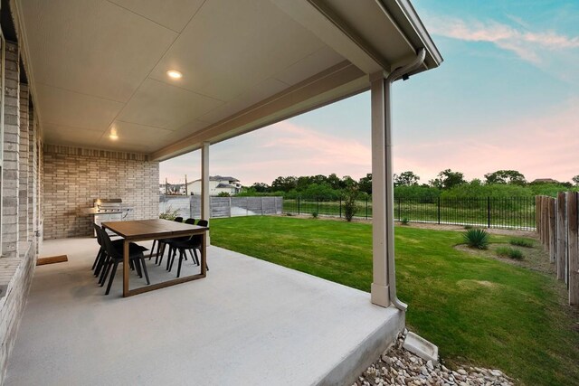 patio terrace at dusk with a yard