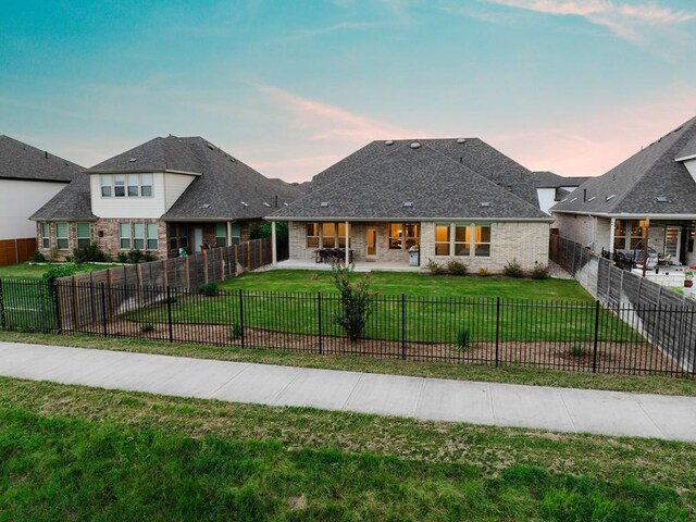 view of front of house with a lawn and a patio area