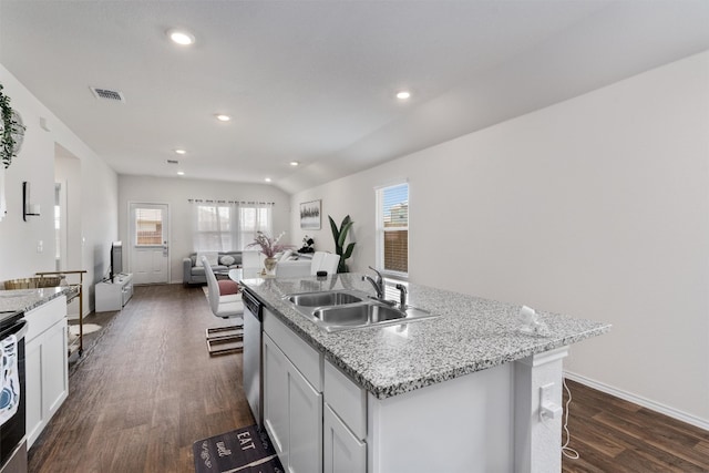 kitchen featuring sink, dark wood-type flooring, white cabinetry, and an island with sink