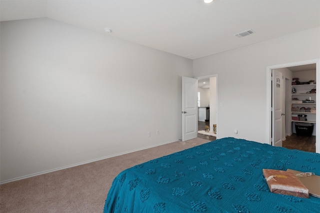 unfurnished bedroom featuring lofted ceiling and carpet floors