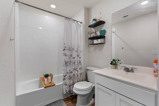 full bathroom featuring shower / tub combo, wood-type flooring, toilet, and vanity