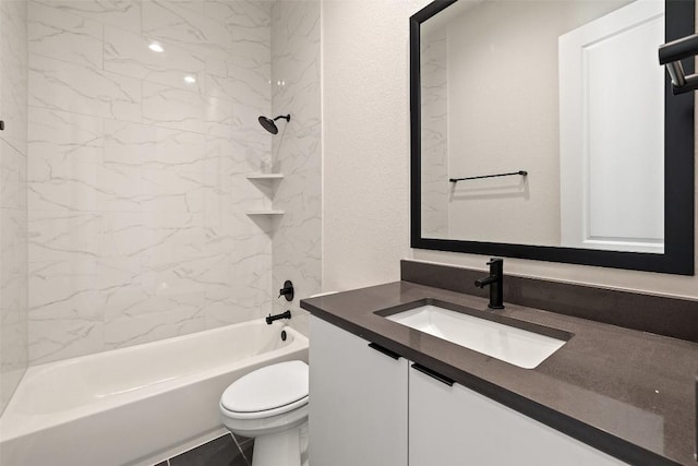 full bathroom featuring toilet, vanity, and tiled shower / bath