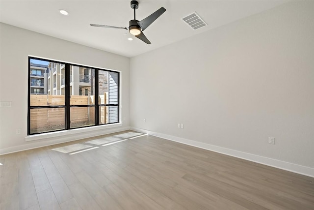 unfurnished room featuring light hardwood / wood-style flooring and ceiling fan