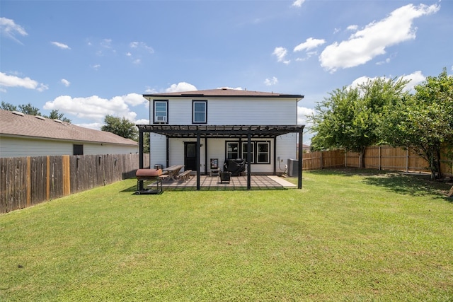 rear view of house with a lawn, a patio area, and central AC