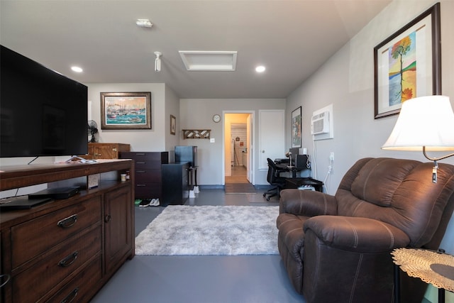 living room featuring concrete floors and an AC wall unit