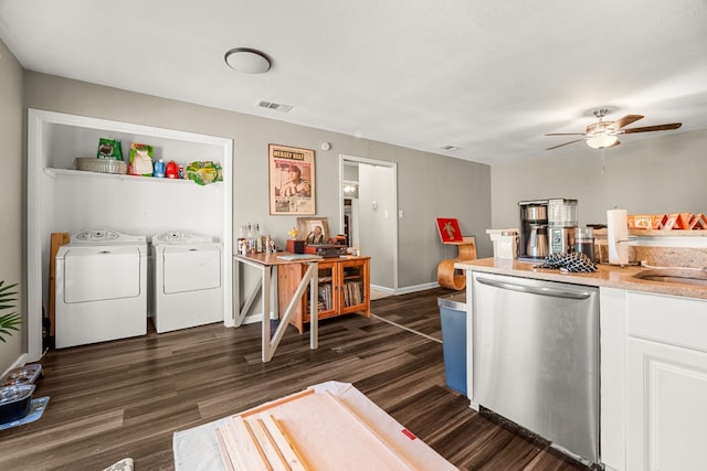 kitchen featuring ceiling fan, washer and dryer, dark hardwood / wood-style floors, stainless steel dishwasher, and white cabinetry